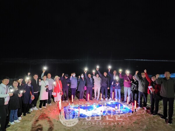  안목 해변에서 평화통일 기원 등불밝히기 기원 퍼포먼스를 열고 있다.